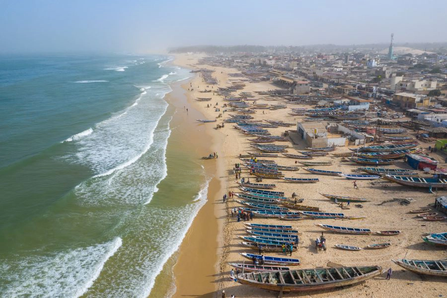 Aerial view of fishing village, pirogues fishing boats across beach